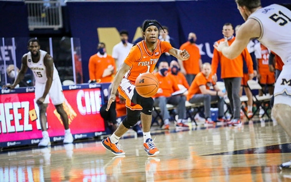 Chaundee Brown Jr. (15) and Austin Davis (51)
