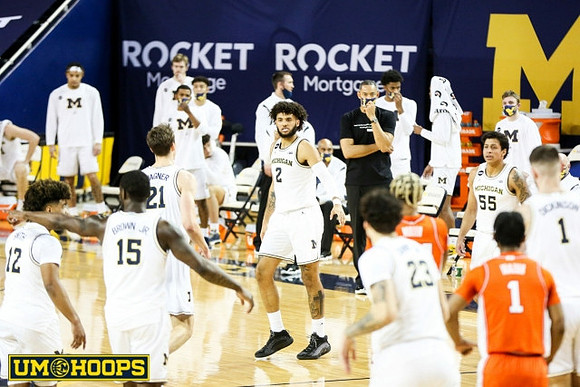 Mike Smith (12), Chaundee Brown Jr. (15), Franz Wagner (21), Isaiah Livers (2), Brandon Johns Jr. (23), Eli Brooks (55), and Hunter Dickinson (1)