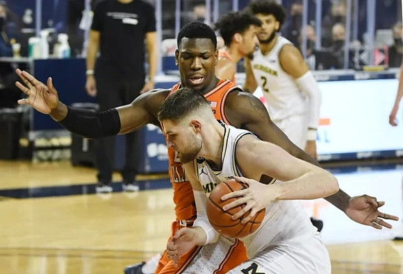 Hunter Dickinson (1) and Isaiah Livers (2)