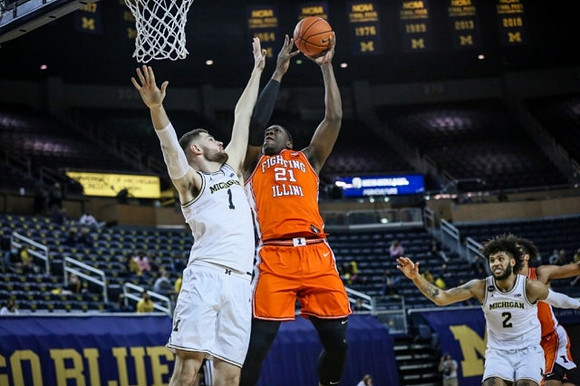 Hunter Dickinson (1) and Isaiah Livers (2)