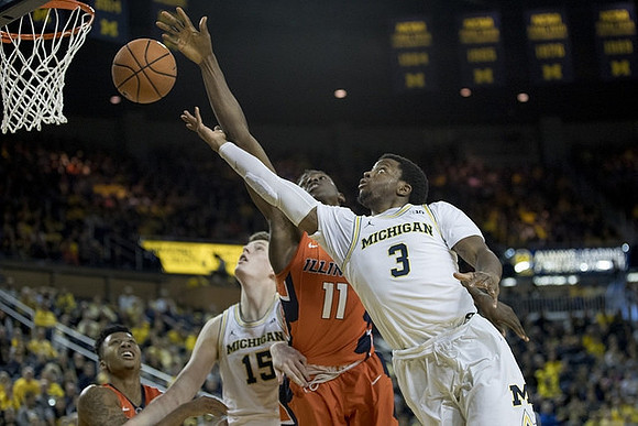Jon Teske (15) and Zavier Simpson (3)