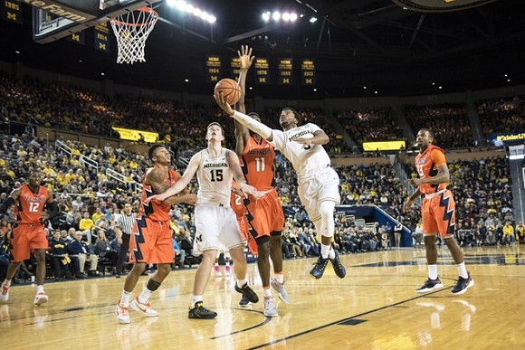 Jon Teske (15) and Zavier Simpson (3)