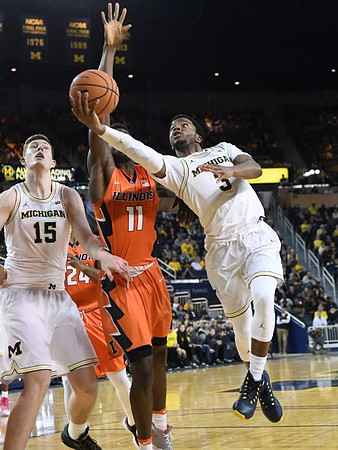 Jon Teske (15) and Zavier Simpson (3)