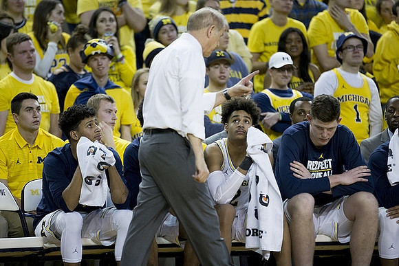 Eli Brooks (55), John Beilein, Jordan Poole (2), and Jon Teske (15)