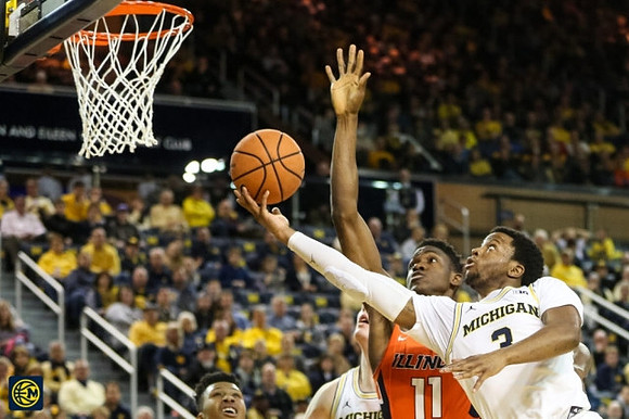 Zavier Simpson (3) and Jon Teske (15)