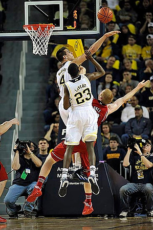 Mitch McGary (4) and Caris LeVert (23)
