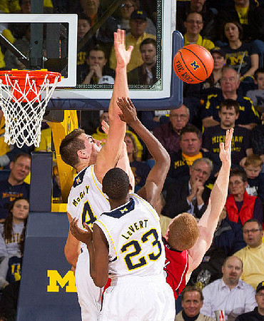 Mitch McGary (4) and Caris LeVert (23)