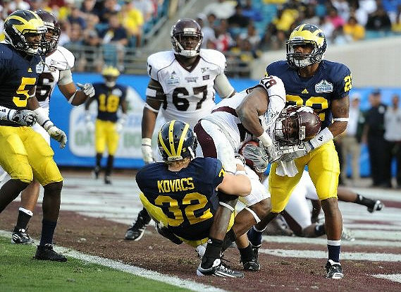 Courtney Avery (5), Jordan Kovacs (32), Floyd Simmons (23), and James Rogers (18)