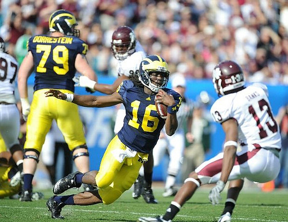 Perry Dorrestein (79) and Denard Robinson (16)