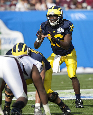 Mark Huyge (72) and Denard Robinson (16)