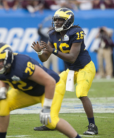 Mark Huyge (72) and Denard Robinson (16)