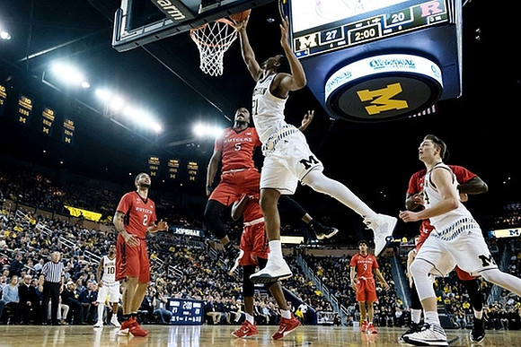 Derrick Walton Jr. (10), Zak Irvin (21), and Mark Donnal (34)