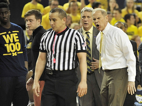Caris LeVert (23), Spike Albrecht (2), Jeff Meyer, and John Beilein