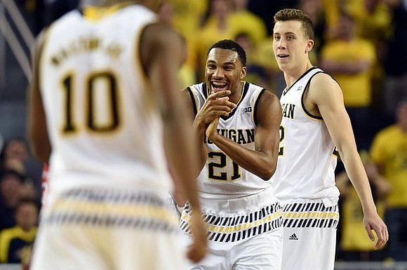 Derrick Walton Jr. (10), Zak Irvin (21), and Duncan Robinson (22)