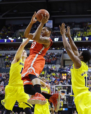 Nik Stauskas (11), Glenn Robinson III (1), and Derrick Walton Jr. (10)