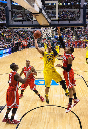 Derrick Walton Jr. (10), Zak Irvin (21), Mitch McGary (4), and Jordan Morgan (52)