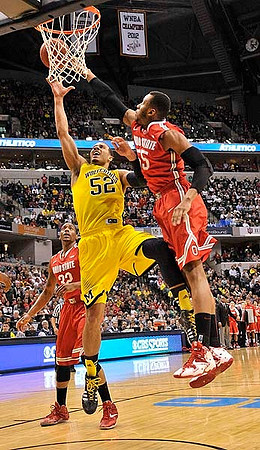 Jon Horford (15) and Caris LeVert (23)