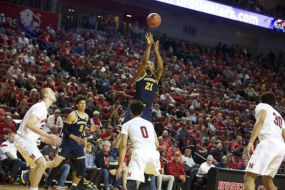 D.J. Wilson (5) and Zak Irvin (21)