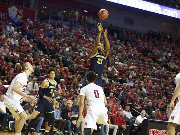 D.J. Wilson (5) and Zak Irvin (21)