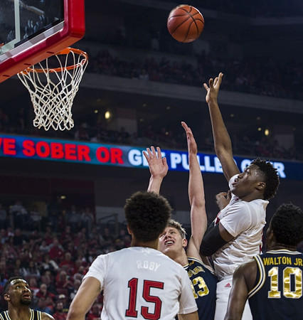 Zak Irvin (21), Moritz Wagner (13), and Derrick Walton Jr. (10)