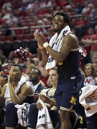 Zak Irvin (21), Mark Donnal (34), and Derrick Walton Jr. (10)