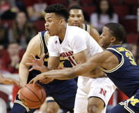 Zak Irvin (21), Mark Donnal (34), and Xavier Simpson (3)