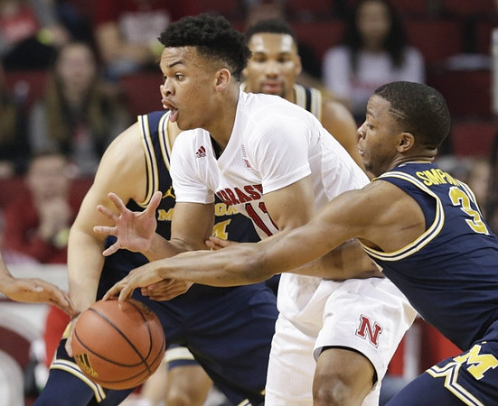 Zak Irvin (21), Mark Donnal (34), and Xavier Simpson (3)
