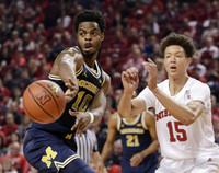 Derrick Walton Jr. (10) and Zak Irvin (21)