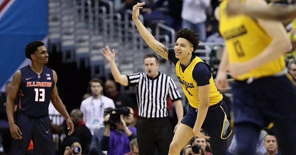 D.J. Wilson (5) and Moritz Wagner (13)
