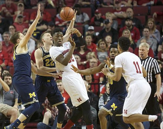 Mark Donnal (34), Duncan Robinson (22), and Derrick Walton Jr. (10)