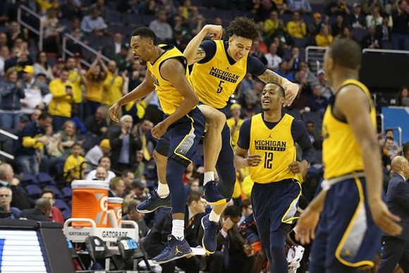Zak Irvin (21), D.J. Wilson (5), Muhammad-Ali Abdur-Rahkman (12), and Xavier Simpson (3)