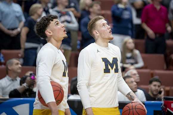 Adrien Nunez (5) and Ignas Brazdeikis (13)