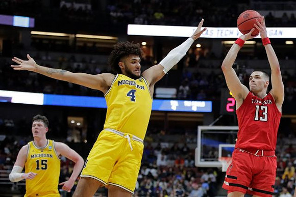 Jon Teske (15) and Isaiah Livers (4)