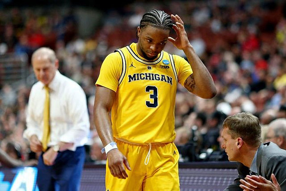 John Beilein, Zavier Simpson (3), and Luke Yaklich