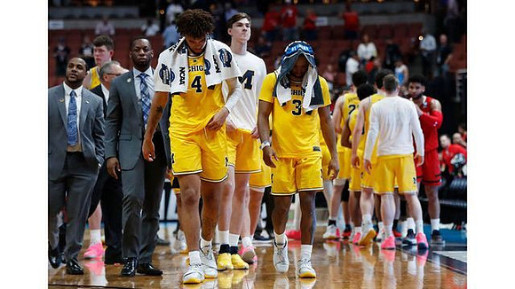 Isaiah Livers (4), Zavier Simpson (3), and Michigan Team