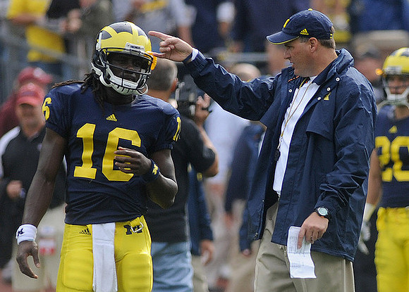 Denard Robinson (16) and Rich Rodriguez