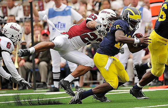 Denard Robinson (16) and Kevin Koger (86)