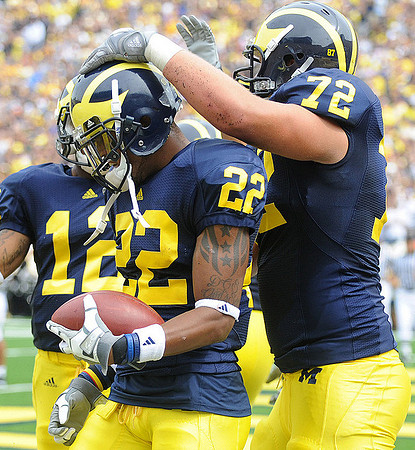 Roy Roundtree (12), Darryl Stonum (22), and Mark Huyge (72)