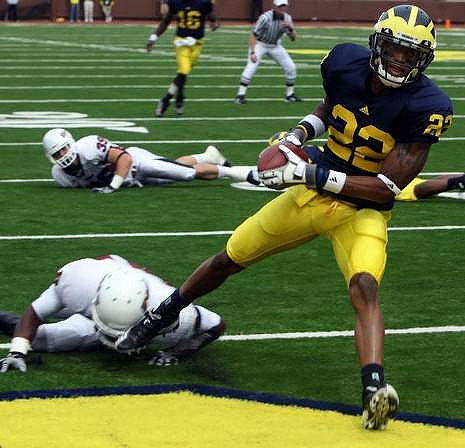 Darryl Stonum (22) and Denard Robinson (16)