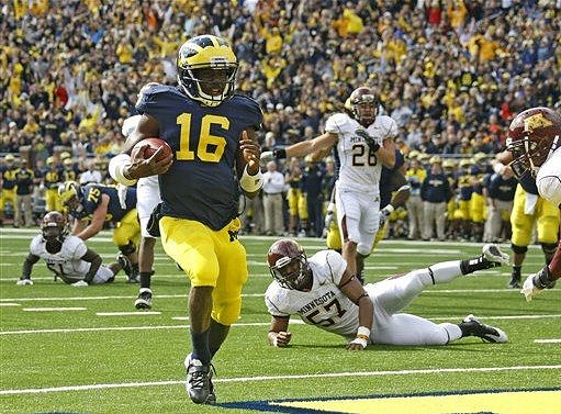 Michael Schofield (75) and Denard Robinson (16)