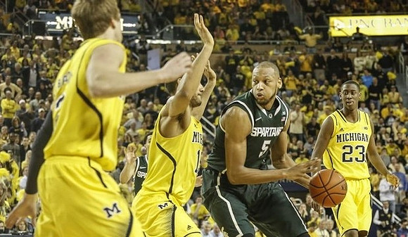 Spike Albrecht (2), Jon Horford (15), and Caris LeVert (23)