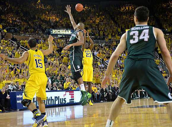 Jon Horford (15) and Caris LeVert (23)