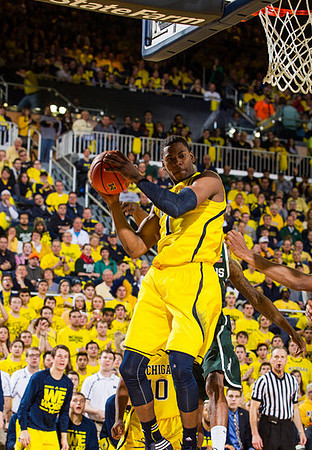 Andrew Dakich (5), Derrick Walton Jr. (10), and Glenn Robinson III (1)