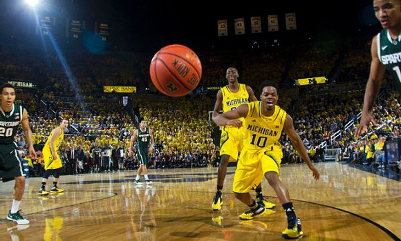 Nik Stauskas (11), Caris LeVert (23), and Derrick Walton Jr. (10)