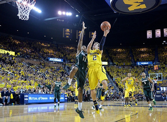 Spike Albrecht (2) and Jon Horford (15)