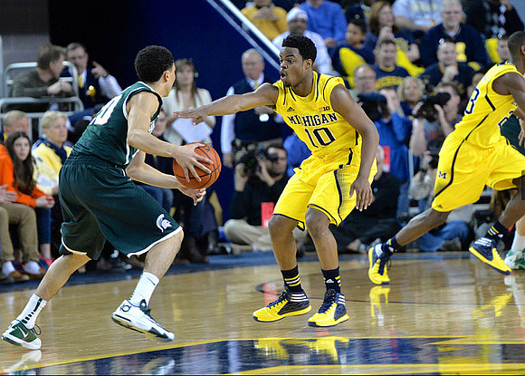 Derrick Walton Jr. (10) and Caris LeVert (23)