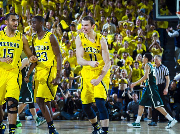 Jon Horford (15), Caris LeVert (23), and Nik Stauskas (11)