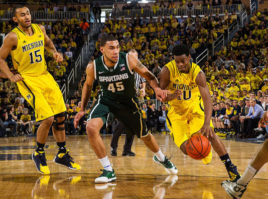 Jon Horford (15) and Derrick Walton Jr. (10)