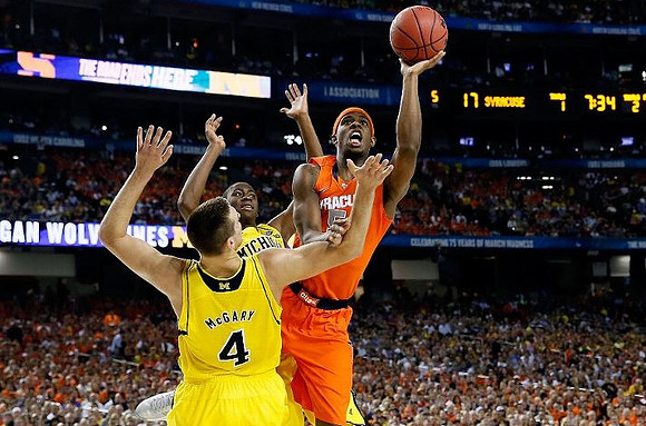 Mitch McGary (4) and Caris LeVert (23)