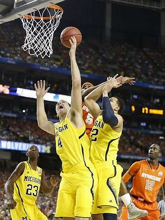 Caris LeVert (23), Mitch McGary (4), and Jordan Morgan (52)